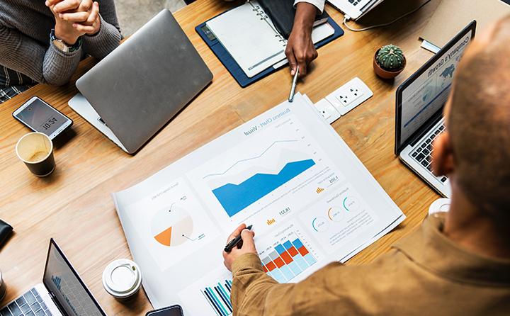 Photo of people examining a business chart